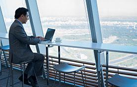 man sitting at a window in a public place