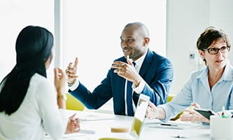 closeup of three people in a large meeting room