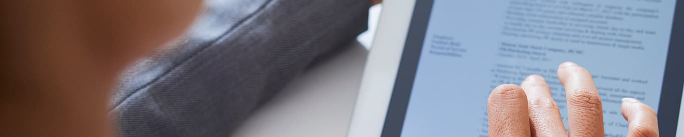 woman reviewing document on a tablet device