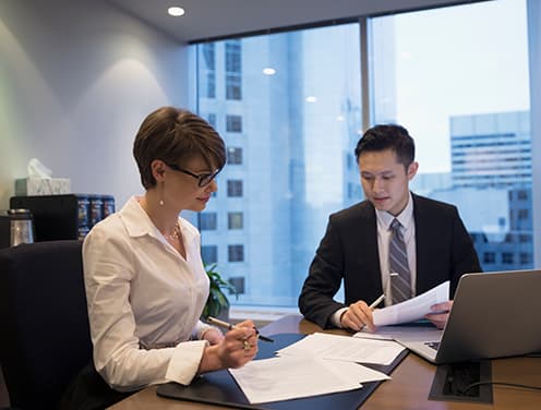 two coworkers working together at desk