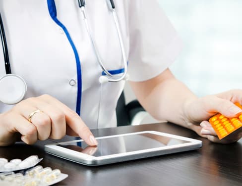 Close up of doctor using a tablet