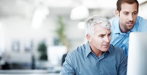 Two men looking at computer screen