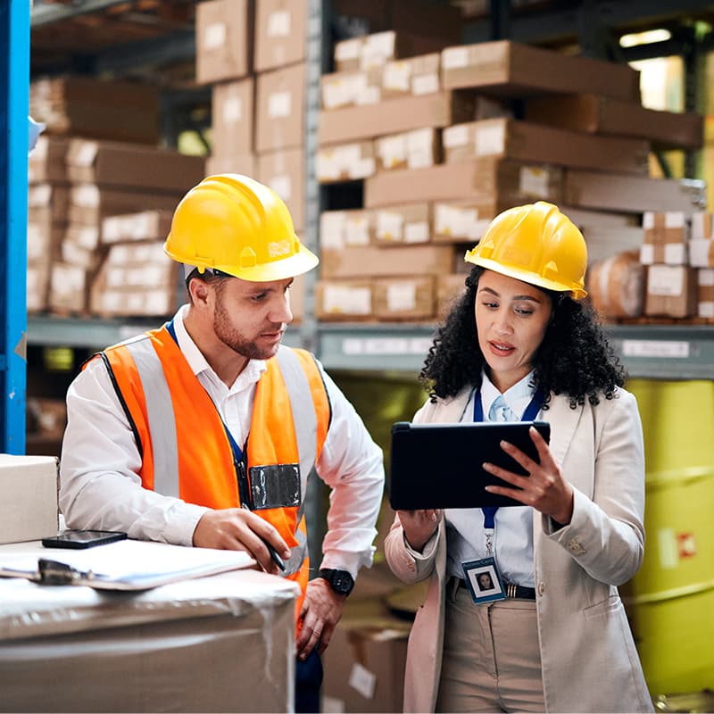 Two professionals working in a supply chain fulfilment center