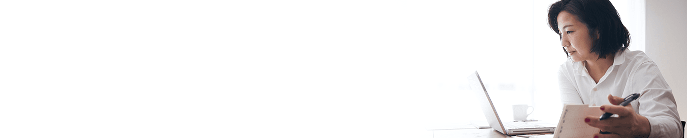 Photo of two people working on a tablet.