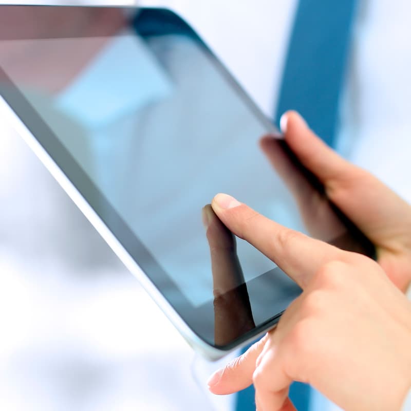 Hands of a web designer using a digital tablet, he is working with a desktop computer.
