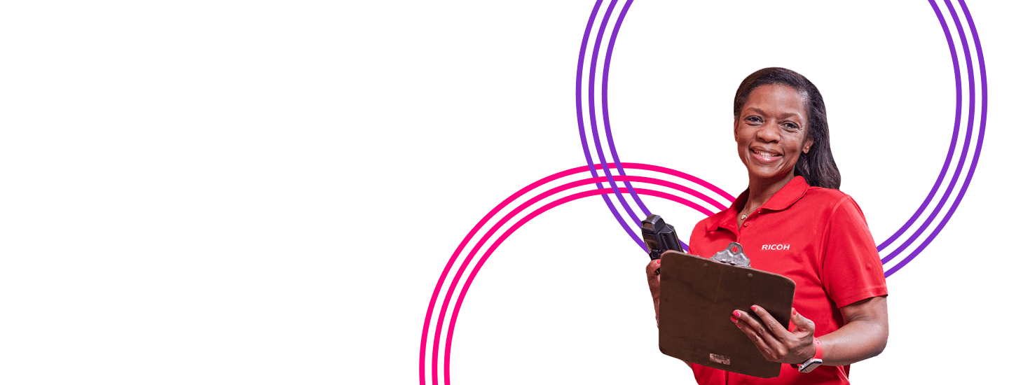 Woman in red shirt and holding a clip board looking at camera