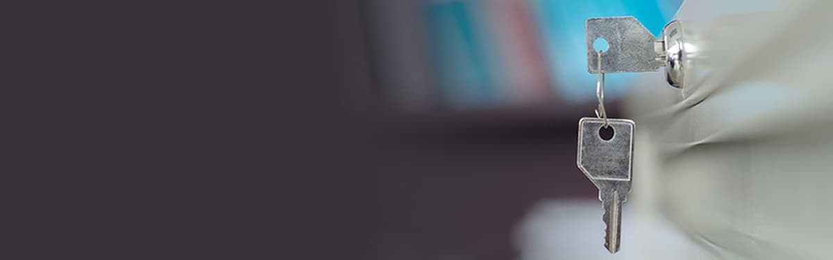 Close up of lock key on filing cabinet