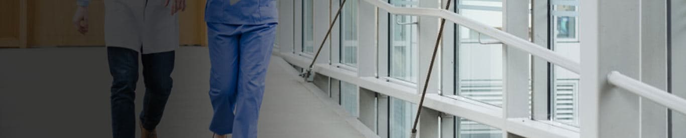 doctor and nurse walking hall talking