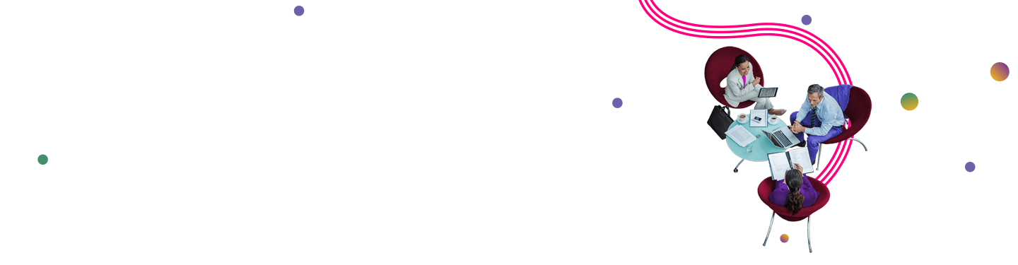 Group of colleagues sitting around a table on tablets and laptops