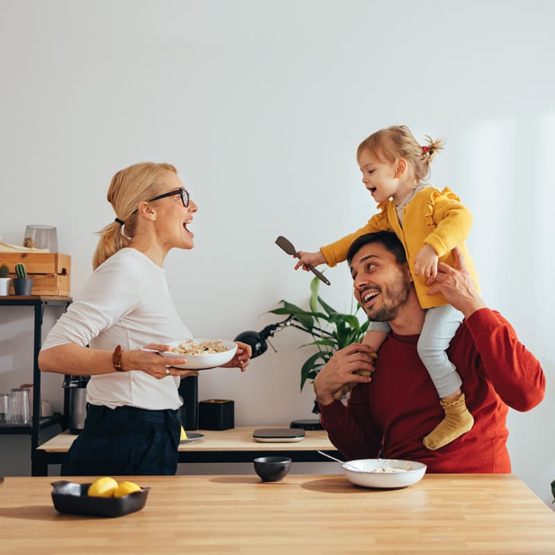 A happy family demonstrating life beyond the office walls, with a number of benefits like paid time off, employee assistance programs, employee discounts, pet insurance and more.