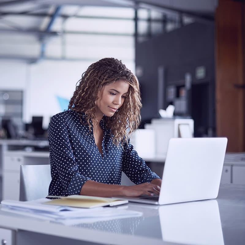 Cropped shot of a young businesswoman working on a laptop in a modern office